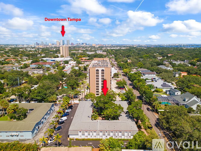 An aerial view of Downtown Tampa with a red arrow pointing to a specific building.