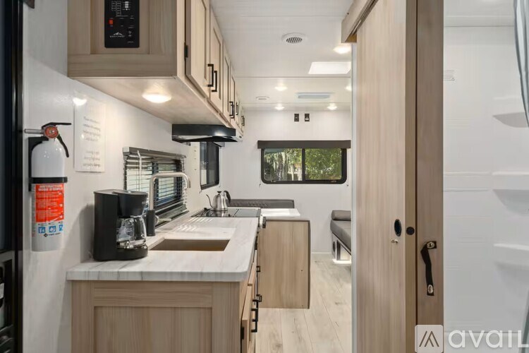 A kitchen area with a sink, microwave, and oven.