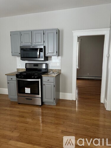 A kitchen with a stove top oven and microwave.