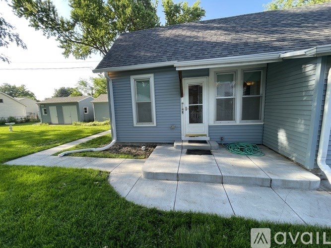 A small house with a front porch is available for rent.