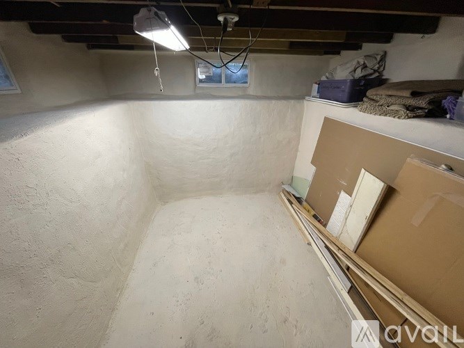 A room with a white wall and a window.