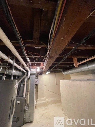 A room with a lot of pipes and a furnace.
