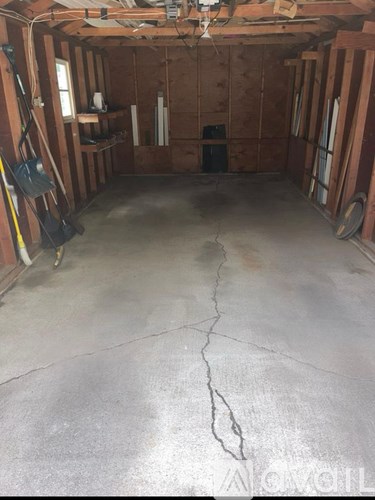 A room under construction with a crack in the floor.