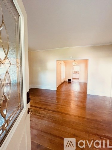 A room with wooden floors and a glass door.
