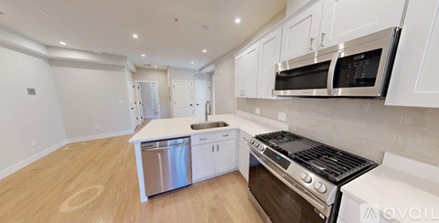 A kitchen with a stove top oven and a microwave above the sink.