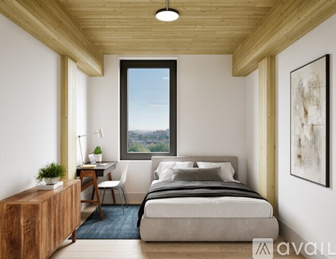 A bedroom with a large bed and a window overlooking a cityscape.
