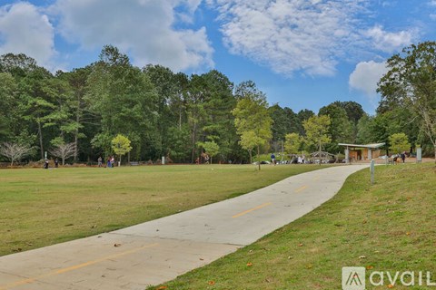 A park with a walking path and trees.