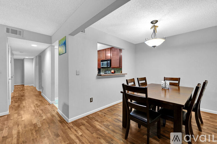 A dining room with a wooden table and chairs.