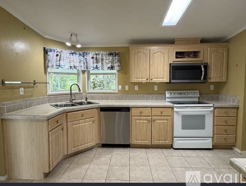 A kitchen with wooden cabinets and a white oven.