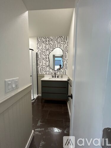 A bathroom with a mirror and a sink.