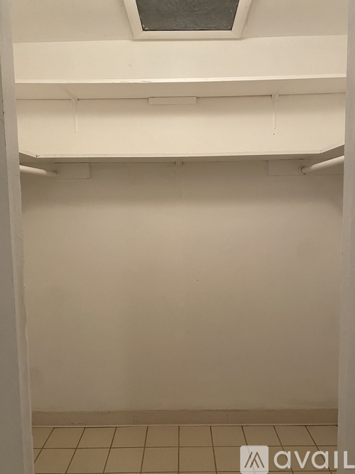 A white shelving unit with a skylight above it.
