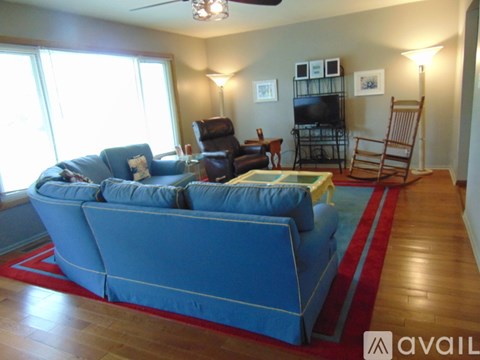 A living room with a blue couch and a television.