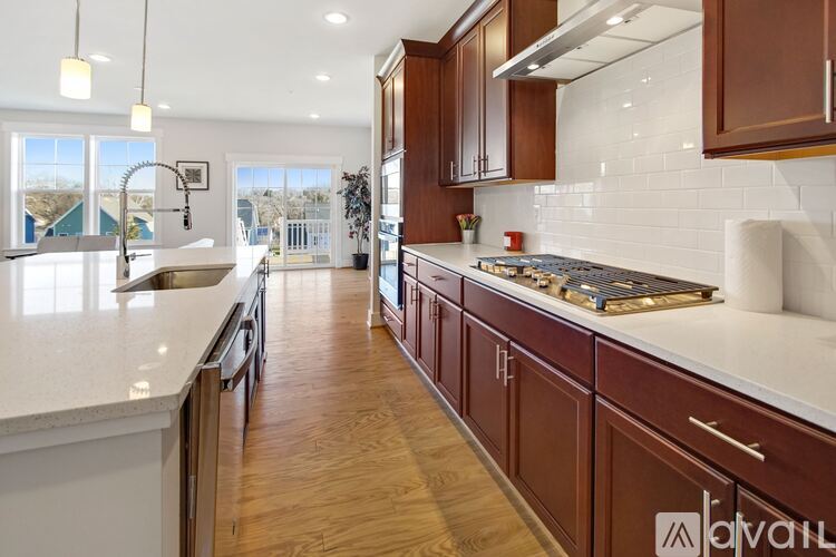 A kitchen with brown cabinets and a white countertop.
