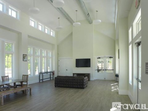 A spacious living room with a television and a fireplace.