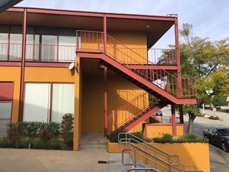 an orange building with stairs and a