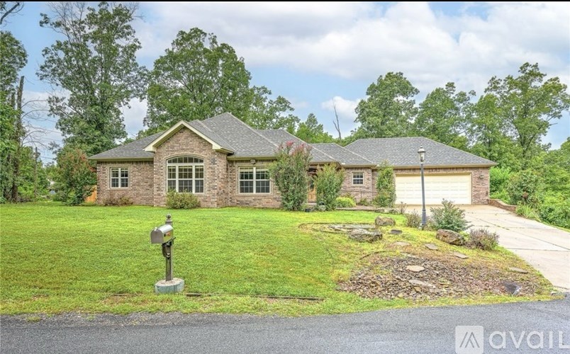 A house with a green lawn and a mailbox in front.