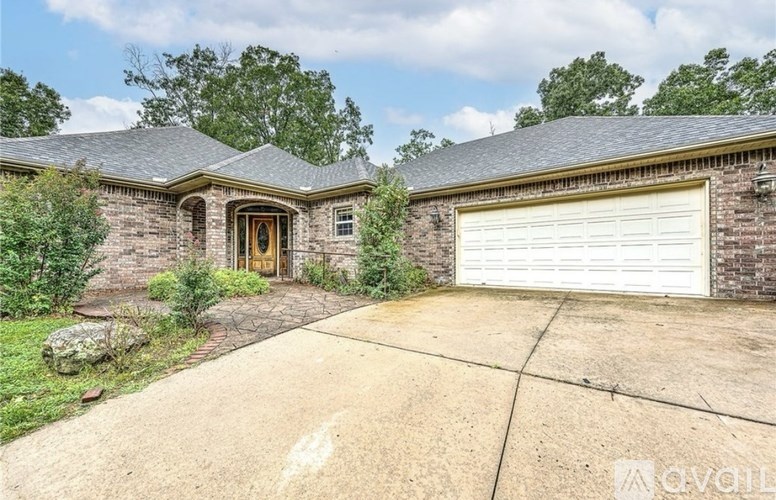 A house with a white garage door and a brown brick exterior.