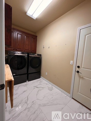 A laundry room with a washer and dryer.