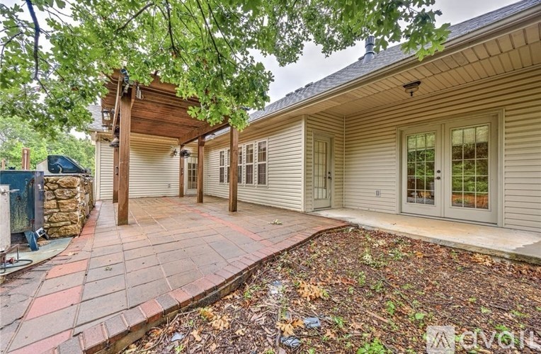 A house with a covered patio and a brick walkway.
