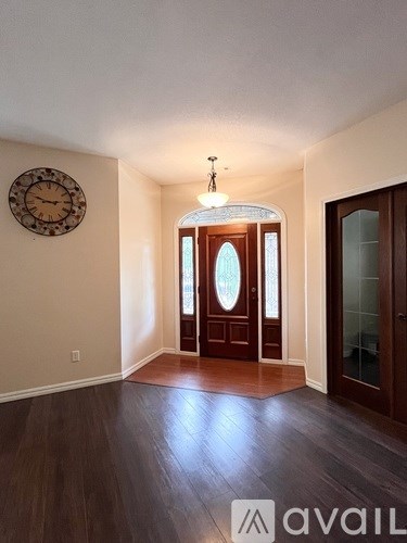 A room with a wooden floor and a glass door.