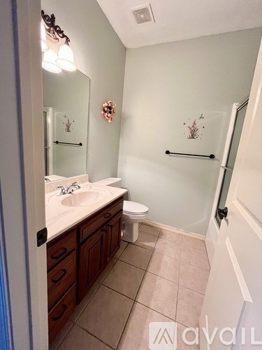 A bathroom with a sink, toilet, and shower.