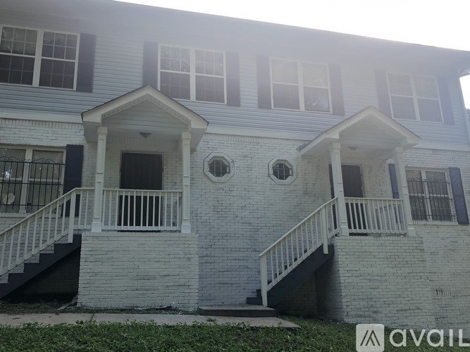A two-story house with a balcony on the second floor.