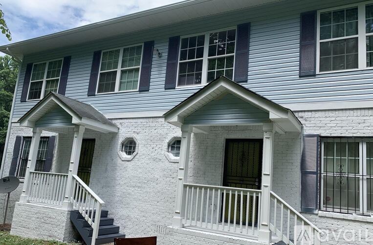 A house with a blue siding and white trim.