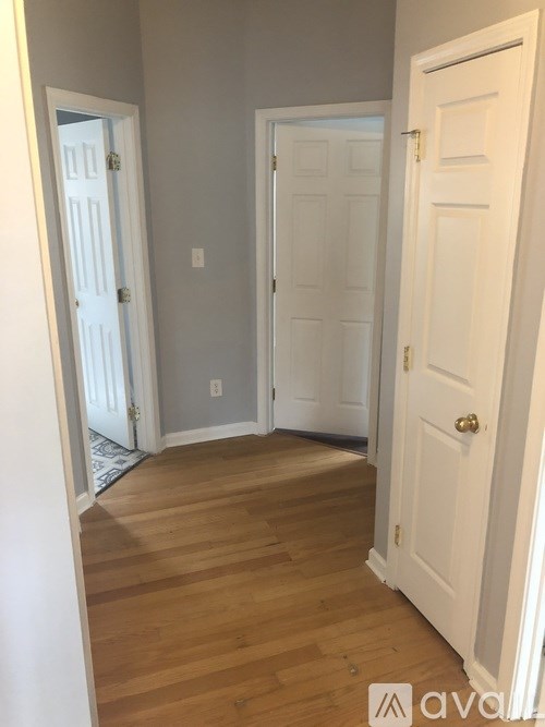 A room with a white door and a white wall.