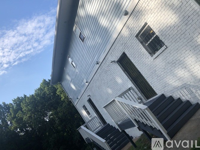A building with a metal roof and a sign that says "AVAIL" on the side.