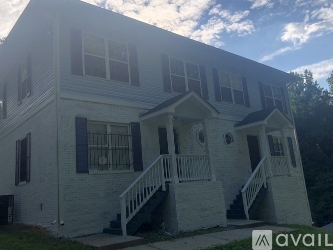 A two-story house with a porch and a balcony.