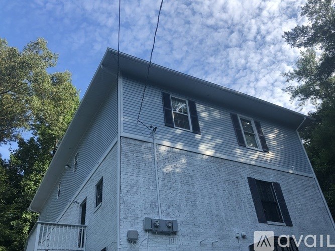 A house with a sign that says "AVAIL" on the side.