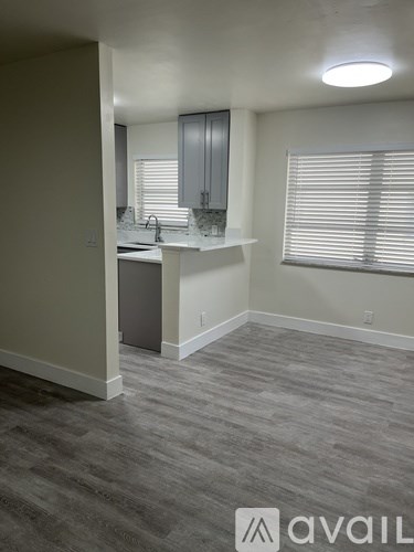 A kitchen area with a counter and cabinets.