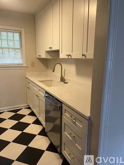 A black and white checkered floor in a kitchen.