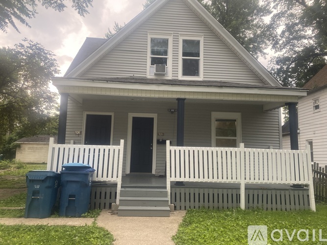 A house with a white porch and a white picket fence.