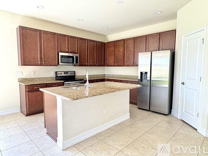 A kitchen with brown cabinets and a granite countertop.