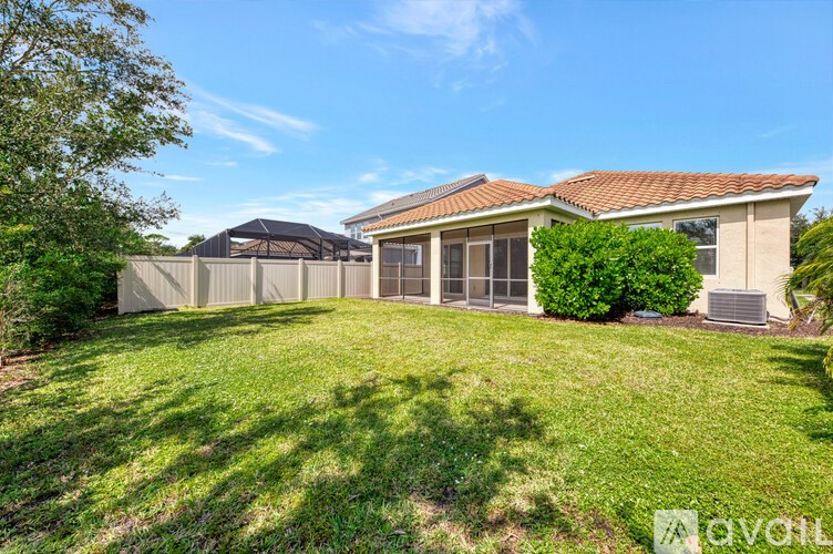 A house with a brown roof and a green lawn in front.