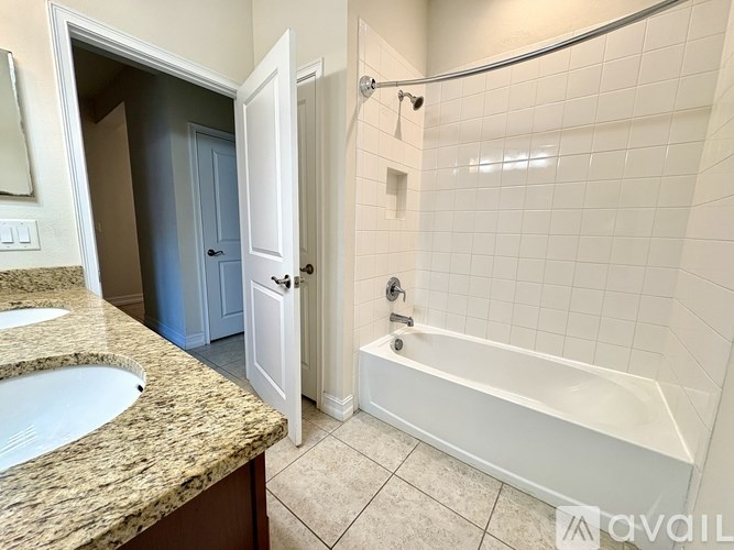 A bathroom with a sink, tub, and shower.