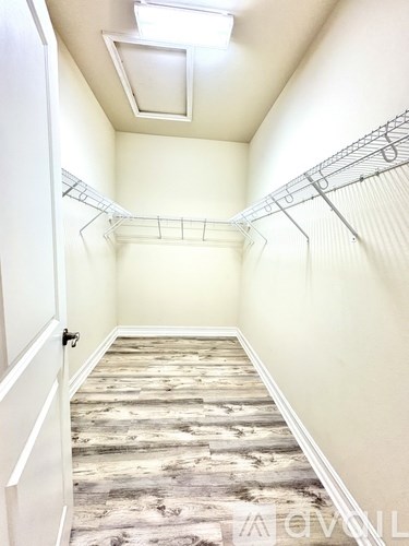 A long hallway with a skylight and a rack on the wall.