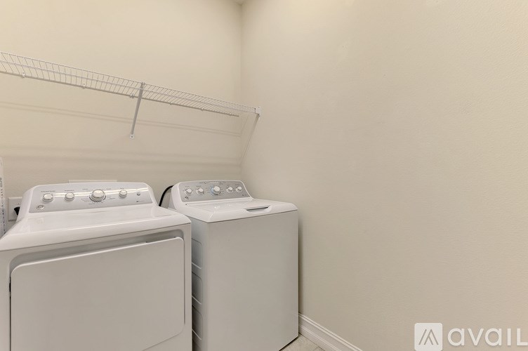 A bathroom with a sink, mirror, and toilet.