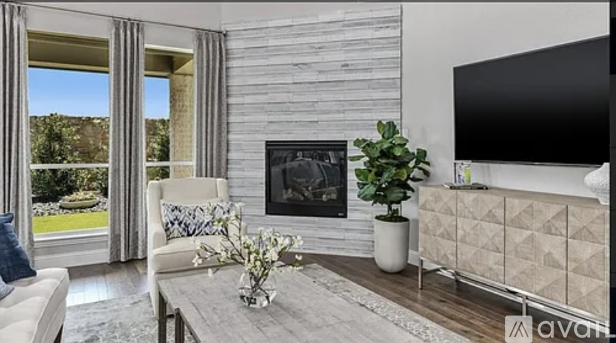 A modern living room with a fireplace and a flat screen TV.