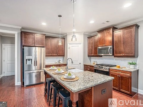 A kitchen with wooden cabinets and a granite countertop.