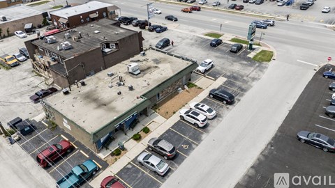 A parking lot with cars and a building in the background.