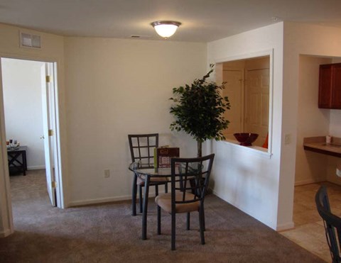 a dining room with a table and chairs