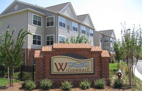 a sign in front of a row of houses