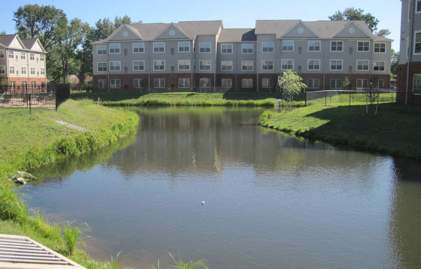 an apartment building overlooks a small body of water