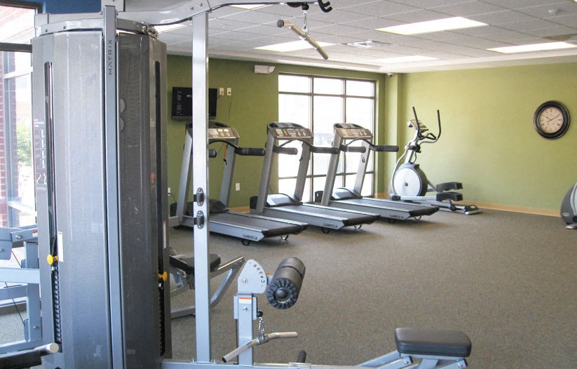 a gym with weights and other exercise equipment in a room