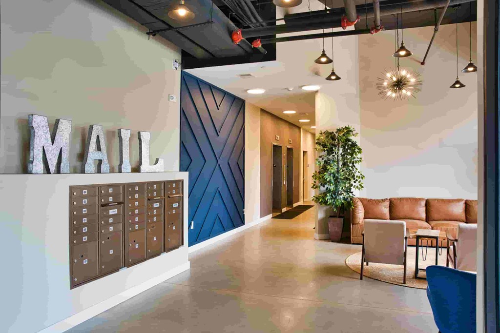 A modern office lobby with a large "MAIL" sign on the wall.