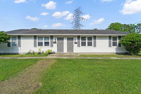 A house with a grey roof and a grey garage door.