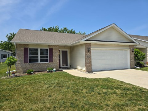 A house with a garage and a driveway.