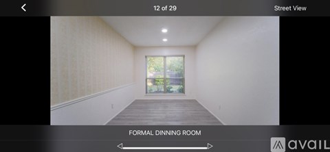 A formal dining room with a view of the street.